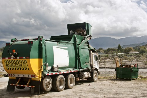 Rear-loading commercial waste vehicle during operation